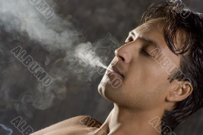 intensively smoking man