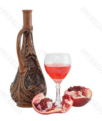 Glass of wine, bottle and a red pomegranate