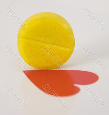 Yellow tablet and heart on playing card