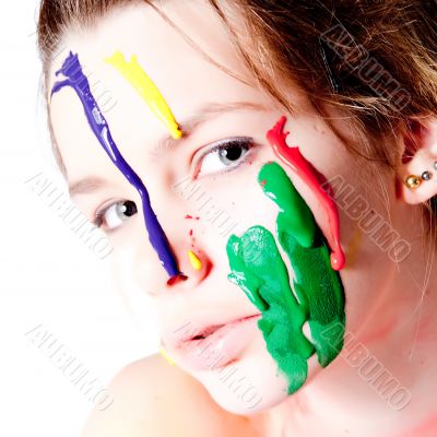Teenage girl with four colors of paint on her face