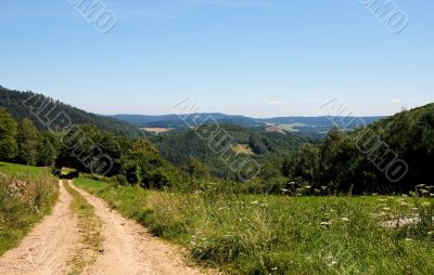 Road among the green hills