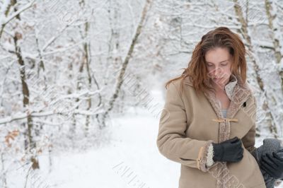 Winter landscape woman standing pensive in the snow