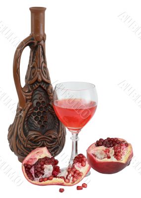 Glass of wine, bottle and a red pomegranate