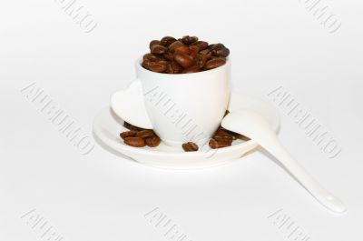 Coffee beans and cup isolated over white