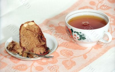 Tea cake with nuts and cup of tea
