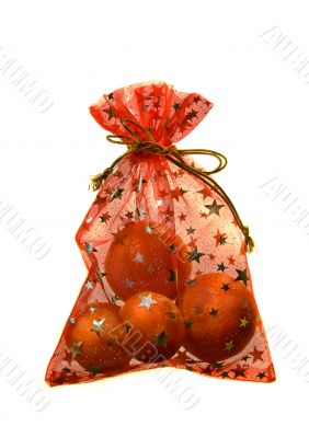 Present sack with oranges inside isolated