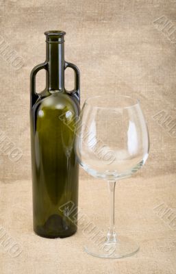 Glass of wine and green bottle