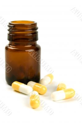 glass bottle with yelllow capsules