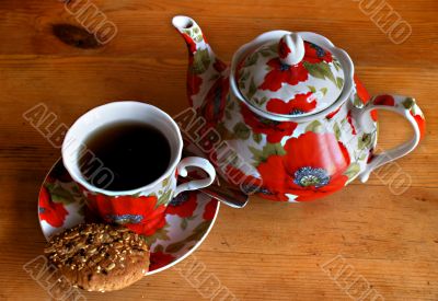 Cookies, cup and teapot on a wooden table