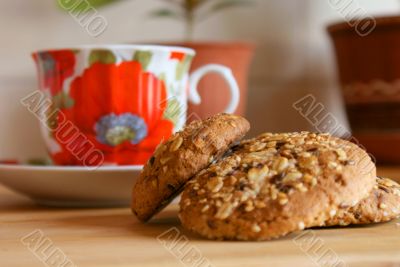 Cookies, cup and teapot on a wooden table