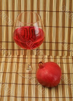 Glass of wine and red pomegranate