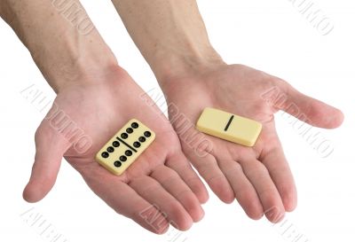 Bones of dominoes on male hands