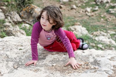 Little girl on the rock