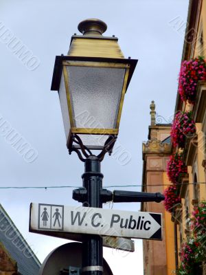 Street lamp with a sign for public toilets in France