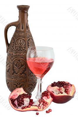 Glass of wine, bottle and a red pomegranate