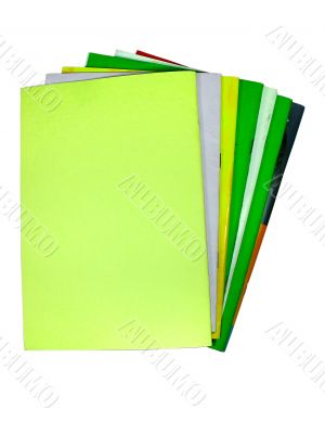 seven colored notebooks isolated over white background