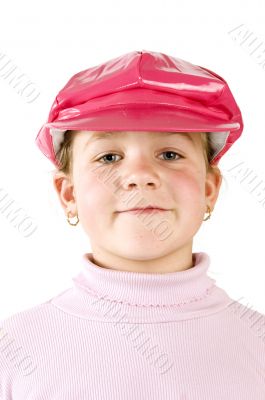 young girl wearing a pink cap with a smile