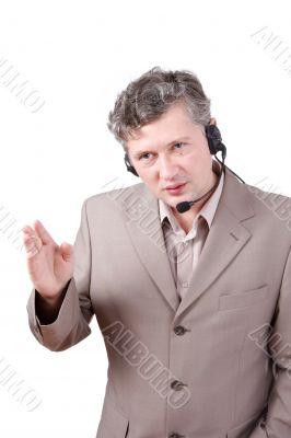 Businessman is speaking over the headset.