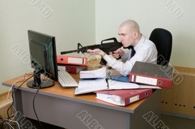 Clerk shoots from a rifle at the monitor