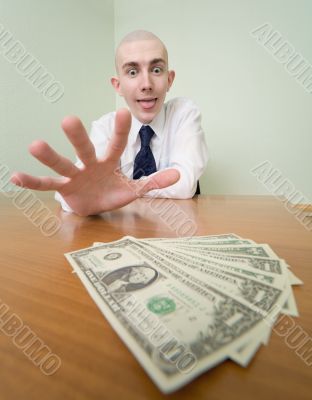 Man reaches for a batch of money