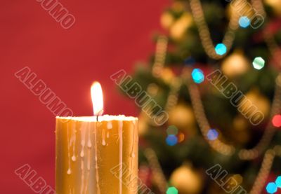 Candle, christmas tree, red background