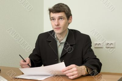 Clerk at office sits at a desktop