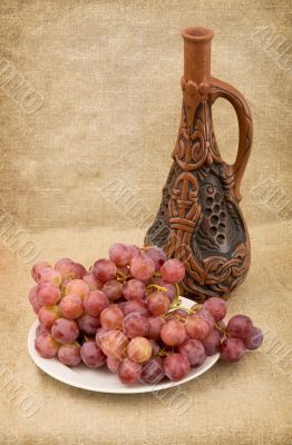 Ceramic brown bottle on canvas background