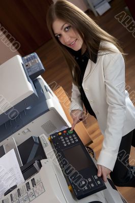 Young business woman at photocopier