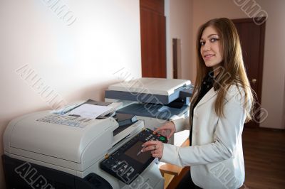 Young business woman at photocopier