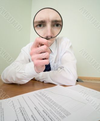 Guy looks through the magnifier