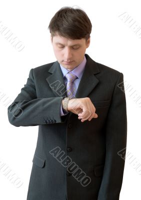 Young man looks at a watch