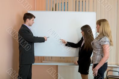 Office workers discuss work