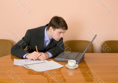Businessman on a workplace with the laptop