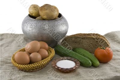 Still-life from vegetarian food. Fresh cucumbers, eggs lying in