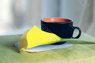 a cup of coffee and a calla