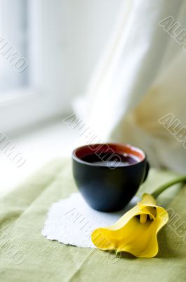 a cup of coffee and a calla