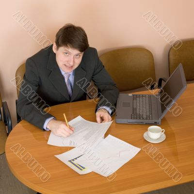 Businessman on a workplace with the laptop
