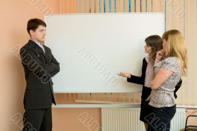 Office workers discuss work