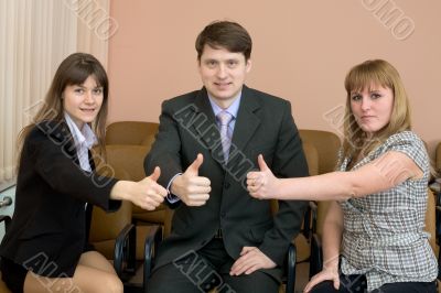 Team of businessmen show thumb up