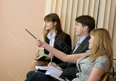 Group of businessmen sitting on armchairs