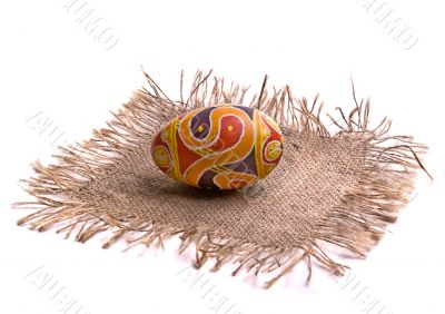 Colorful Easter egg on the napkin, isolated.