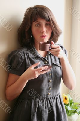 woman drinks a cup of coffee