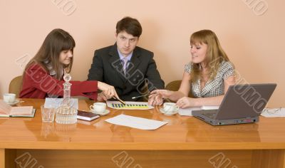 Business team sits at the table