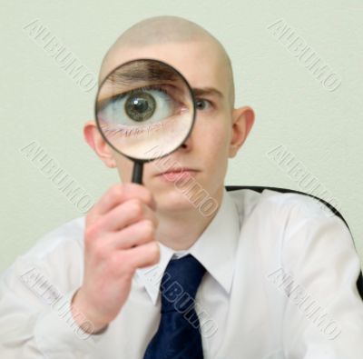 Guy looks through the big magnifier