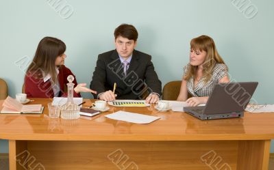 Business team sits at the table