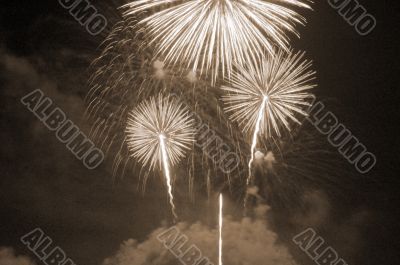 Fireworks lighting up the sky sepia