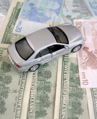 The silvery car on euro and dollars