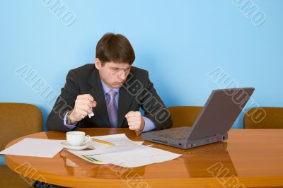 Businessman on a workplace with the laptop