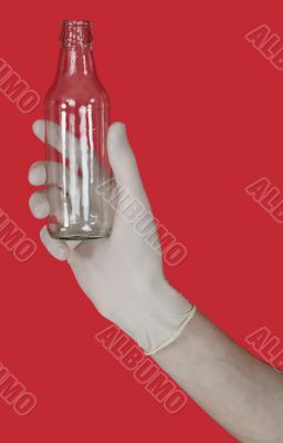 Empty glass bottle on the male hand