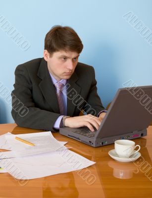 Businessman on a workplace with the laptop